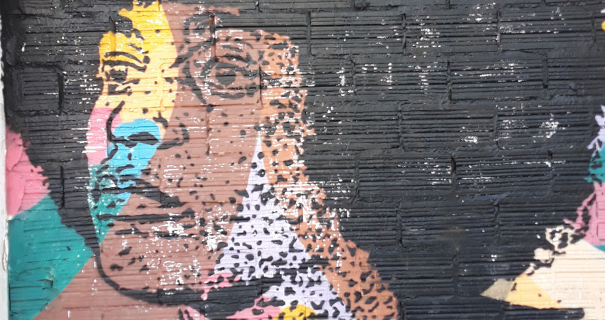 painting of person on brick wall