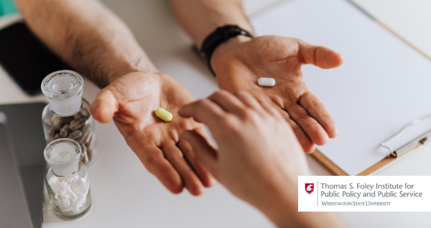 two hands holding pills