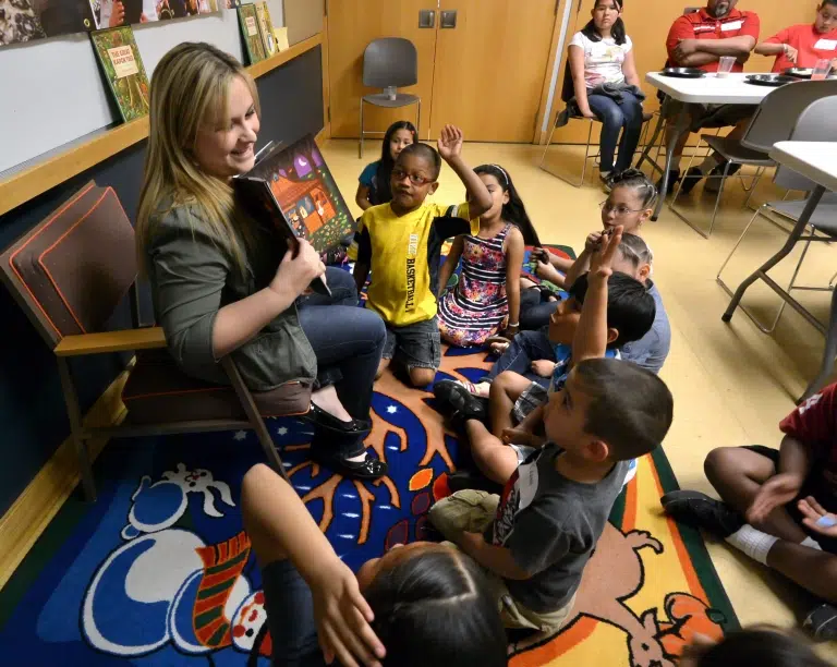 woman reading to a group of children